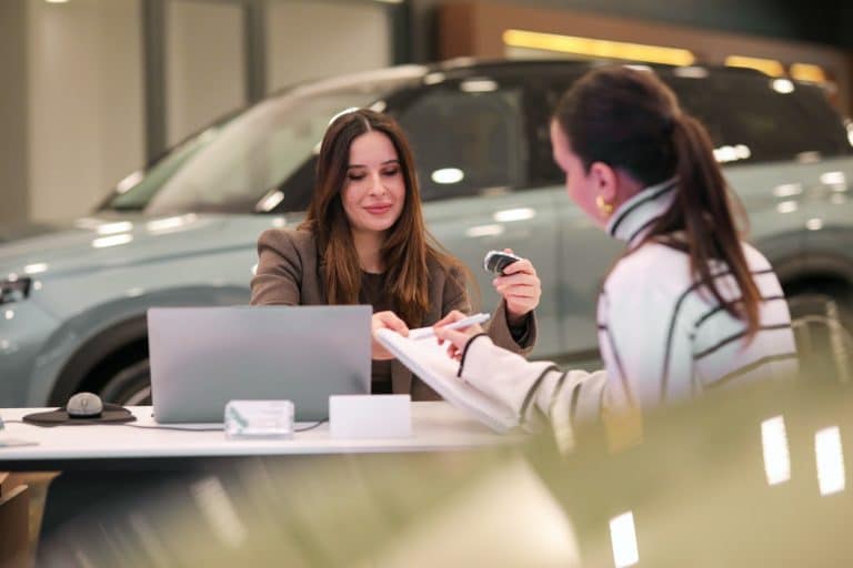 woman purchasing vehicle at dealership credit union auto loan